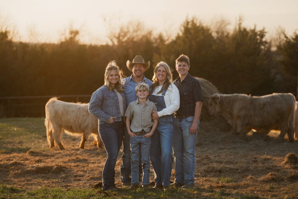 The Tesch family out in the pasture with the herd