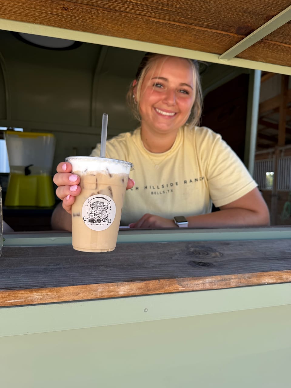 A Highland Hill Coffee cup at the trailer window